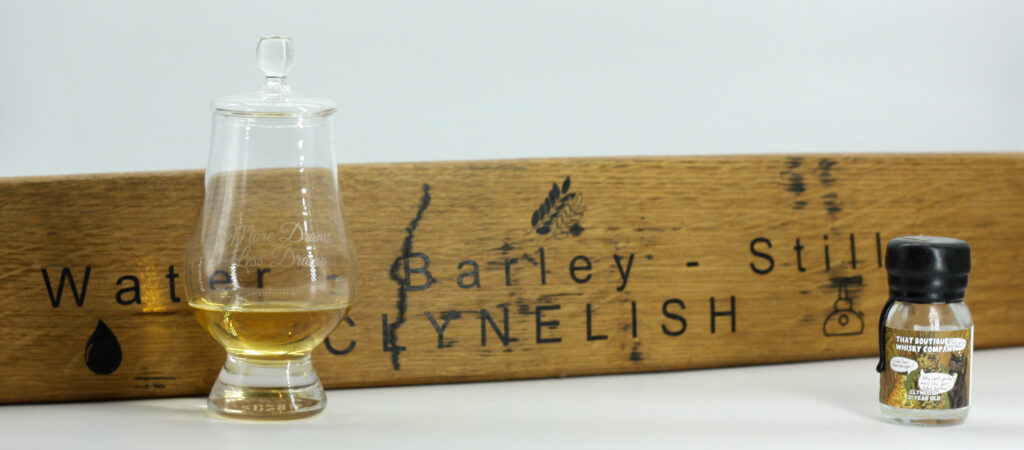 Glass of Clynelish in front of an engraved stave from Clynelish